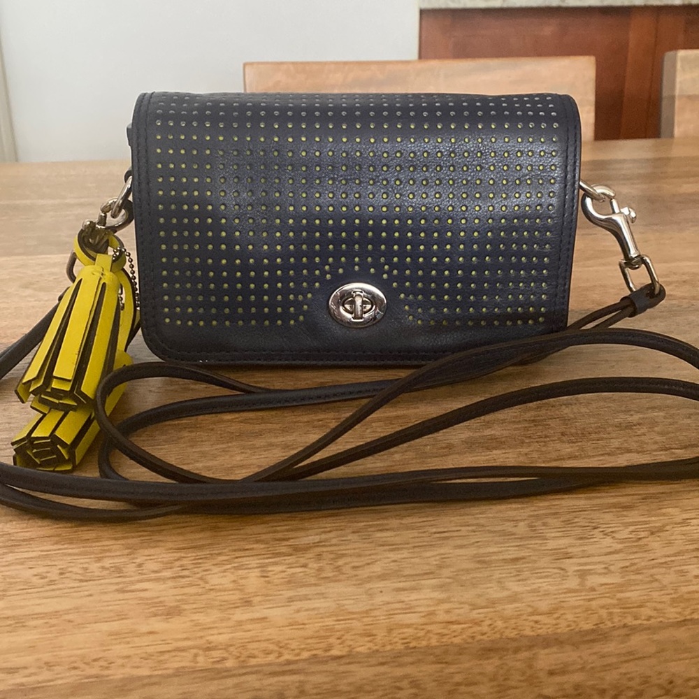 Small genuine navy leather Coach handbag with bright yellow accent color
